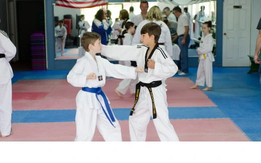 a group of people in karate uniforms