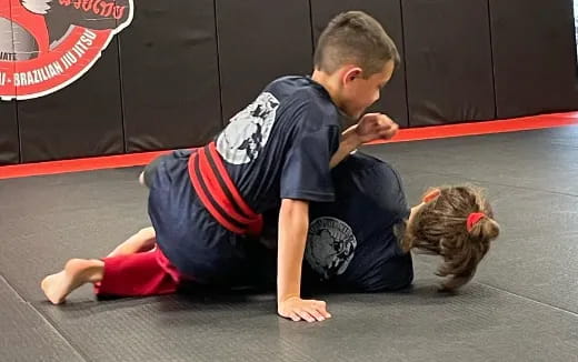 a boy and a girl wrestling