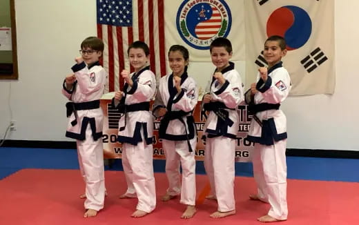 a group of kids in karate uniforms