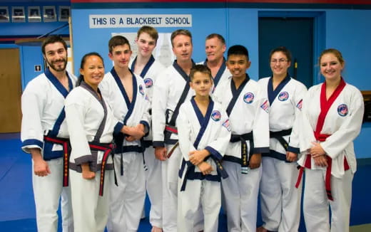 a group of people in white karate uniforms