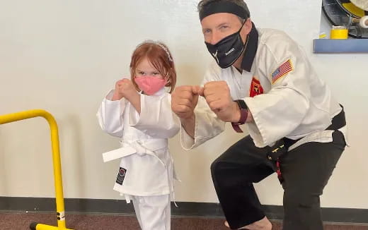 a person and a child in white karate uniforms
