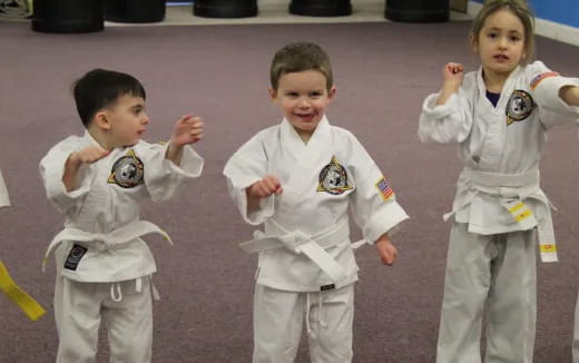 a group of children in karate uniforms