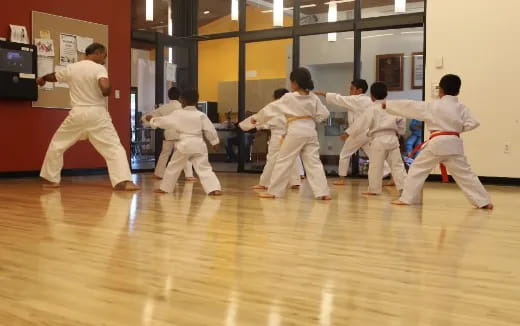 a group of kids practicing martial arts