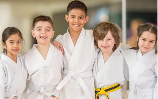 a group of children wearing white robes