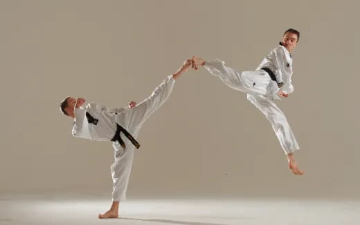 a group of people in karate uniforms