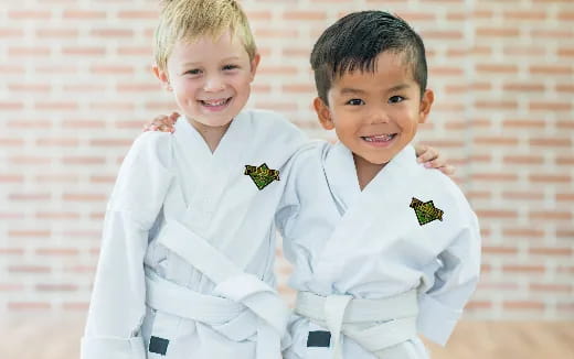 two children wearing white uniforms