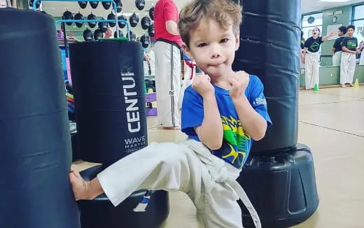 a boy sitting on a gym chair