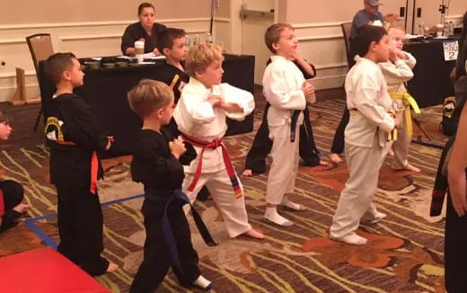 a group of children in karate uniforms