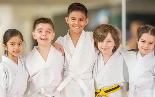 a group of children wearing white lab coats