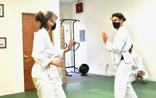 a couple of people wearing white uniforms and masks