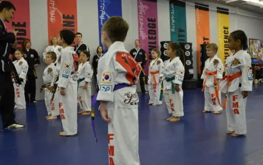 a group of children in karate uniforms