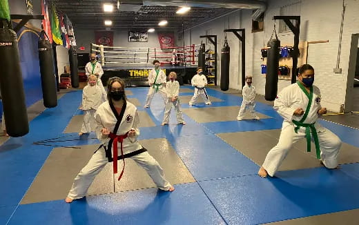 a group of people in a karate class