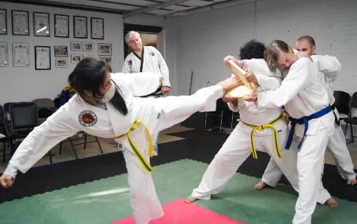 a group of people in karate uniforms