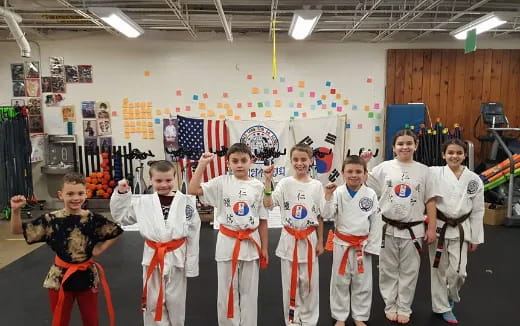 a group of kids in karate uniforms