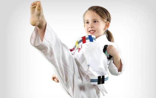 a young girl in a karate uniform