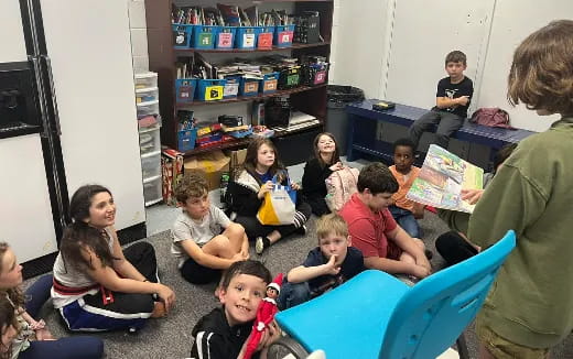 a group of children sitting in a room