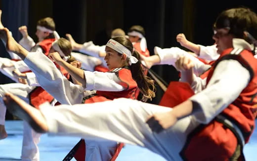 a person in a red and white uniform with the arms up