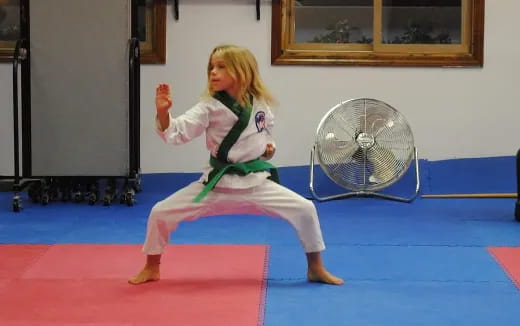 a girl in a karate uniform