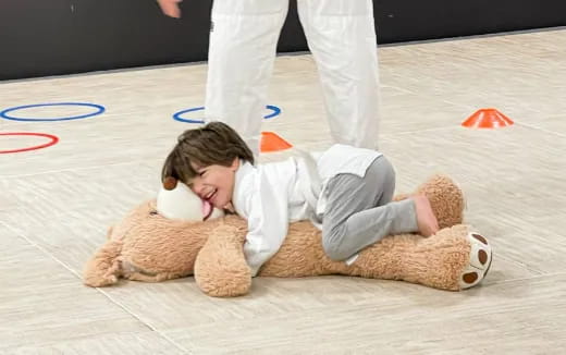 a baby lying on a teddy bear