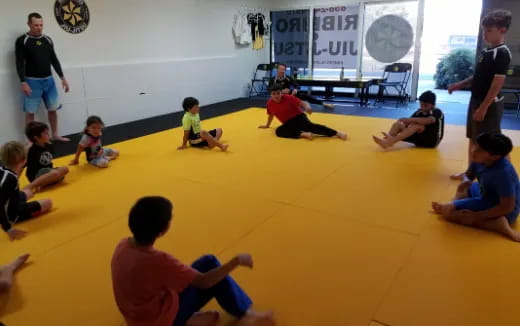 a group of kids sitting on the floor in a room