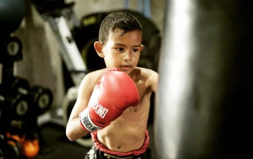 a young boy in a boxing ring