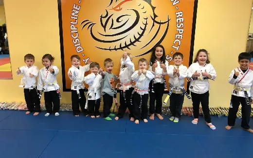 a group of children in white shirts