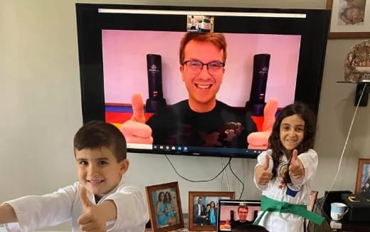 a person and two children in front of a television