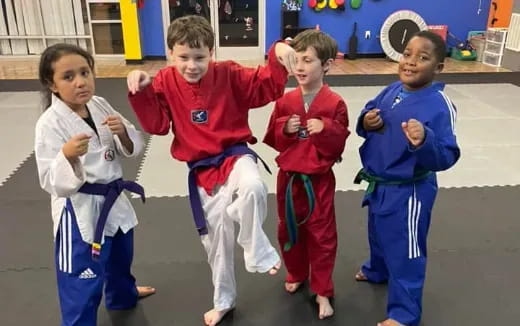 a group of children in karate uniforms