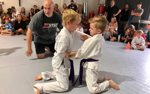 a person and a boy practicing karate