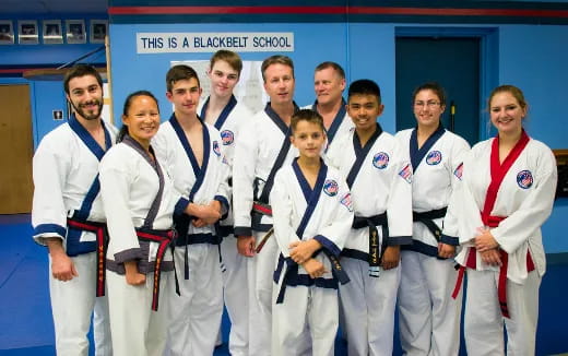 a group of people in white karate uniforms