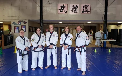 a group of people in karate uniforms