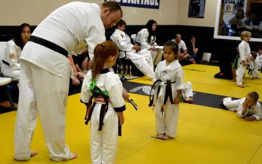 a group of people in karate uniforms