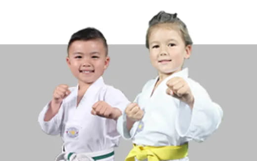 a couple of kids wearing karate uniforms