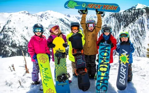 a group of snowboarders pose for a photo