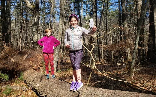 a person and a child walking in the woods