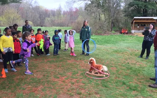 a group of people and a dog in a park