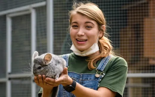 a person holding a small animal