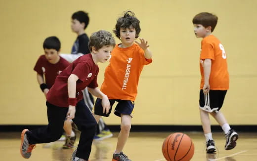 a group of kids playing basketball