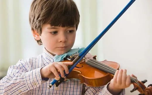 a boy playing a violin