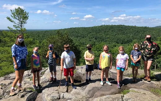 a group of people standing on a hill