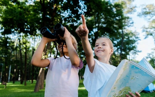 a man holding a camera and a child holding a sign