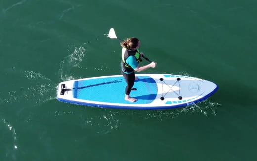 a girl on a paddle board