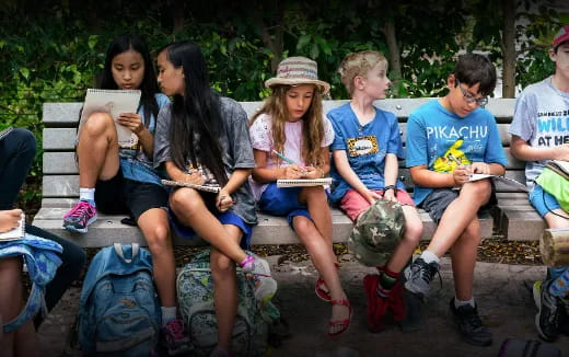 a group of people sitting on a bench