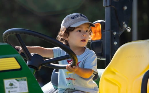 a child in a yellow tractor