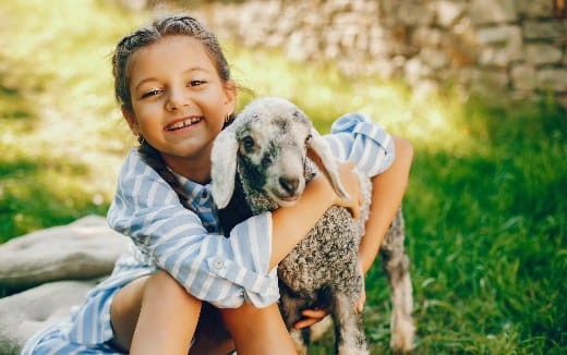 a child holding a dog