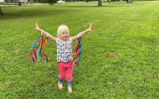 a little girl flying a kite