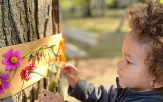 a child smelling flowers
