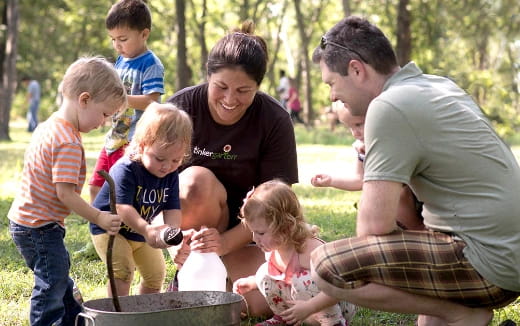 a group of people playing with a bucket of water