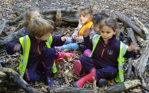 a group of children sitting on a log
