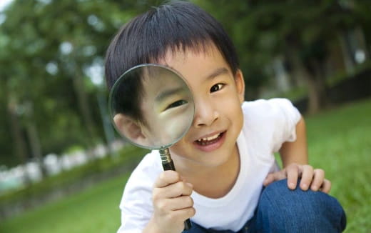a child holding a magnifying glass